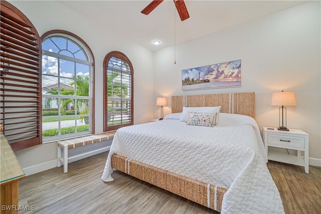 bedroom with multiple windows, light wood-type flooring, and ceiling fan