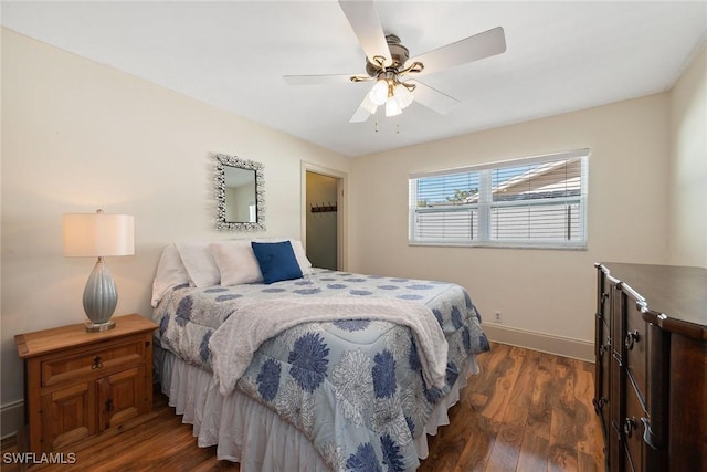 bedroom with dark hardwood / wood-style flooring and ceiling fan