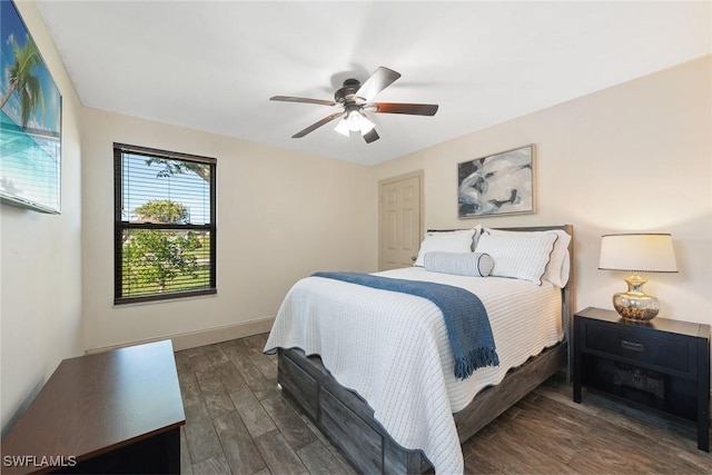 bedroom with dark wood-type flooring and ceiling fan