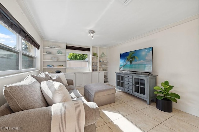 living room with built in shelves, ornamental molding, and light tile patterned floors