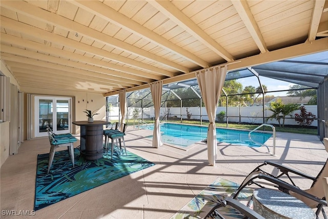 view of swimming pool featuring a patio and glass enclosure