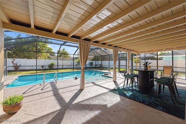 view of swimming pool featuring glass enclosure and a patio area