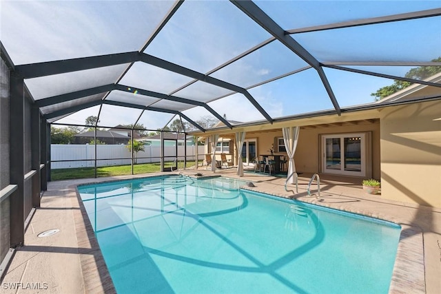 view of pool with a patio and glass enclosure