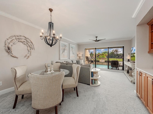 dining space with baseboards, ornamental molding, and light colored carpet