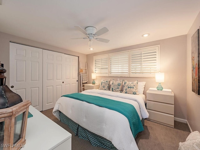 bedroom featuring dark colored carpet, a closet, a ceiling fan, and baseboards