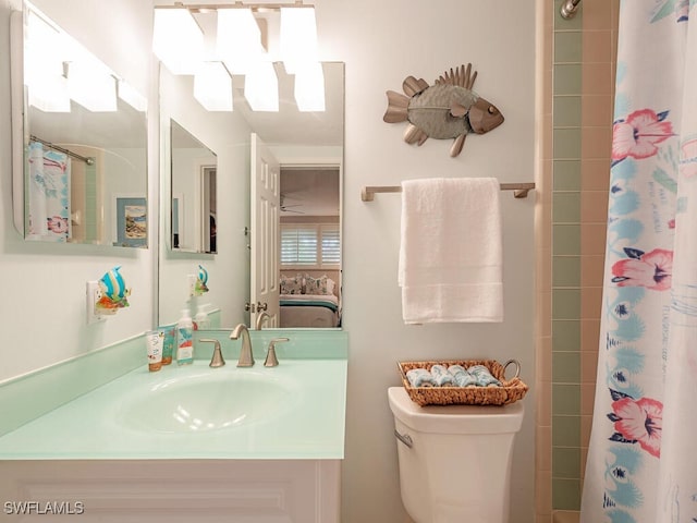 ensuite bathroom featuring a shower with curtain, vanity, toilet, and ensuite bathroom