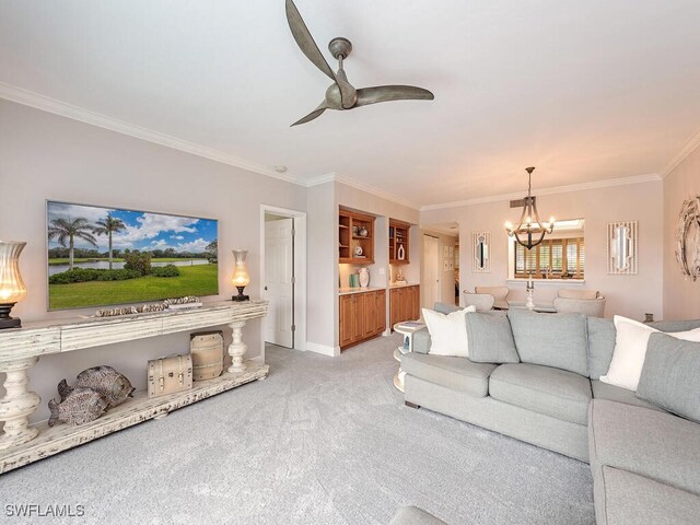 carpeted living room with ceiling fan with notable chandelier and crown molding