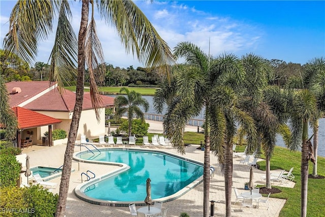 pool featuring a community hot tub and a patio