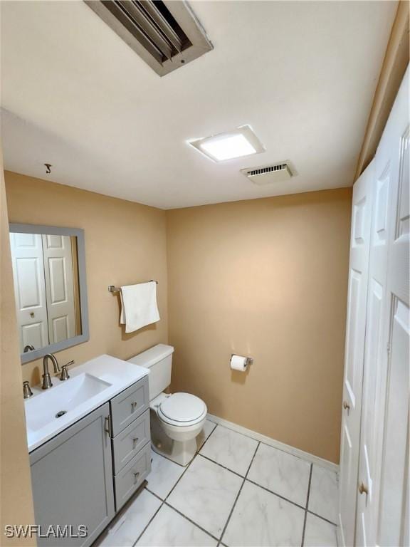 bathroom featuring toilet, tile patterned floors, and vanity