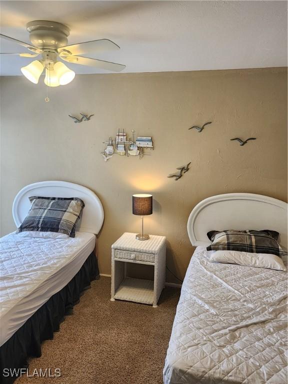 bedroom with ceiling fan and carpet