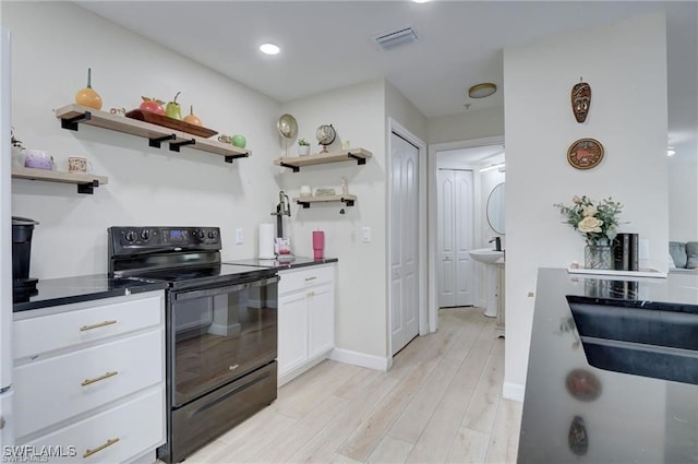 kitchen featuring light hardwood / wood-style floors, white cabinetry, and black range with electric stovetop