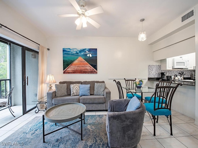 tiled living room with ceiling fan