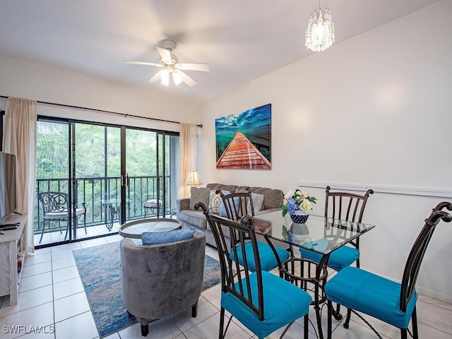 tiled dining space featuring ceiling fan with notable chandelier