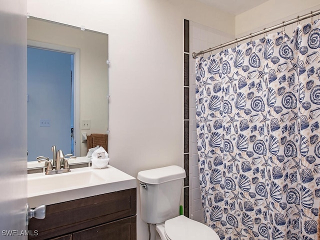 bathroom featuring a shower with curtain, vanity, and toilet