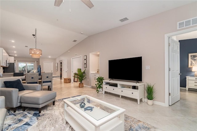 living room featuring ceiling fan, vaulted ceiling, and light tile patterned floors