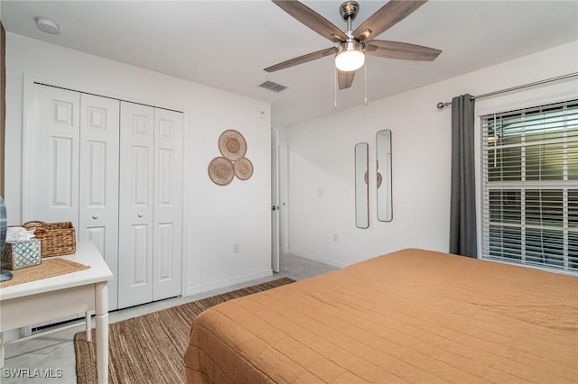 bedroom with ceiling fan and a closet