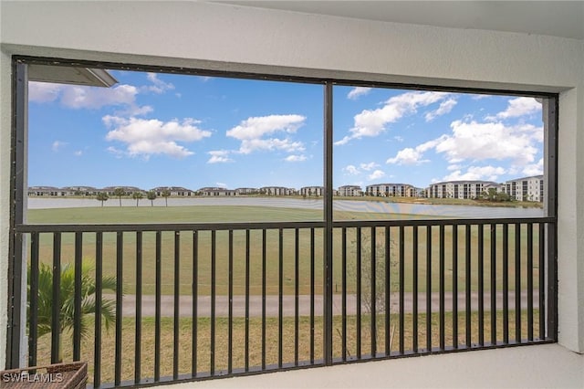 unfurnished sunroom with a water view