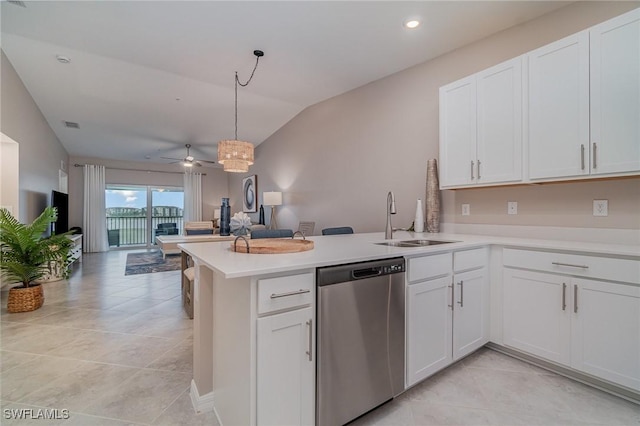 kitchen with decorative light fixtures, dishwasher, kitchen peninsula, and white cabinets