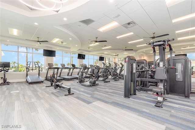 workout area with light colored carpet and a paneled ceiling