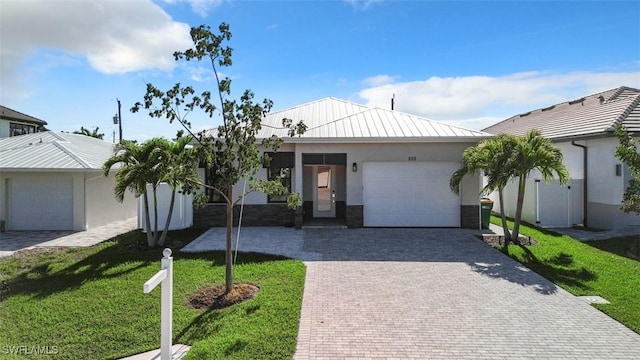 view of front of property with a garage and a front yard