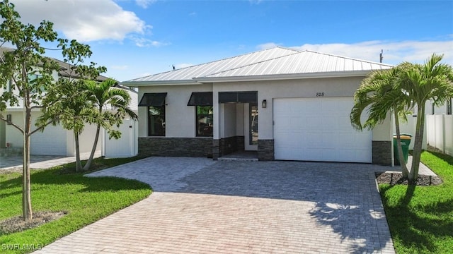 view of front of property with a garage and a front yard