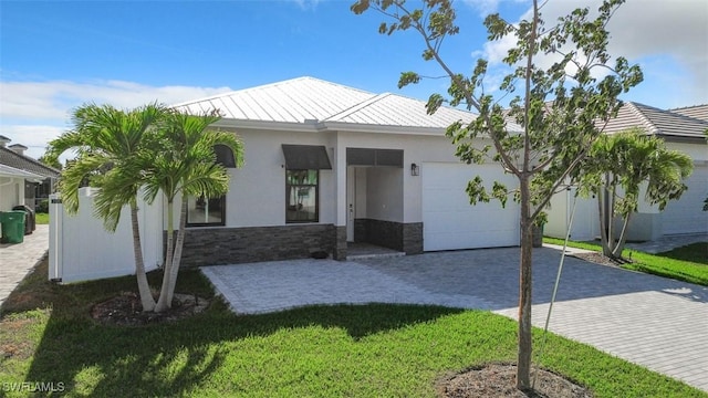 view of front facade with a garage and a front lawn