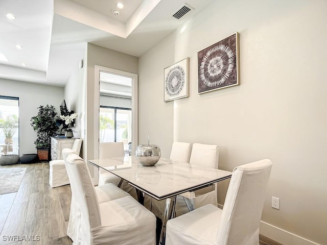 dining room featuring light hardwood / wood-style floors and a healthy amount of sunlight