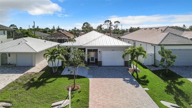 view of front of home featuring a garage and a front yard