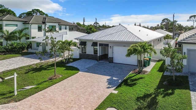 view of front of property with a garage and a front yard