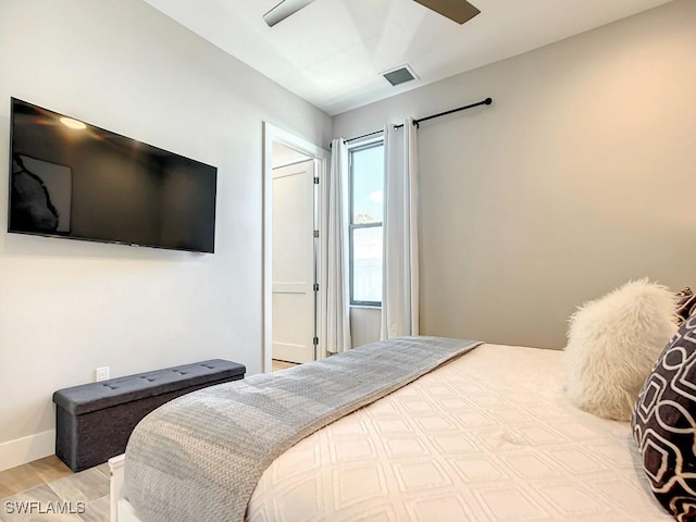 bedroom with ceiling fan and light hardwood / wood-style floors