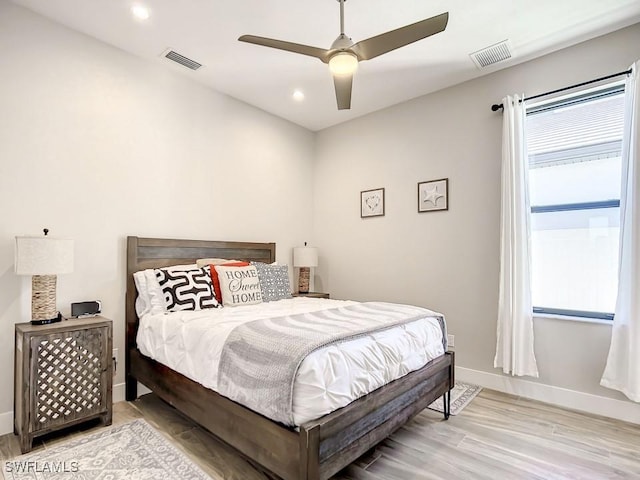 bedroom with ceiling fan and light hardwood / wood-style floors