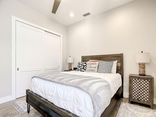 bedroom with ceiling fan, hardwood / wood-style floors, and a closet