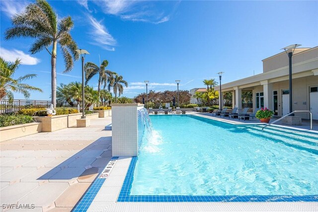 view of pool featuring pool water feature and a patio area