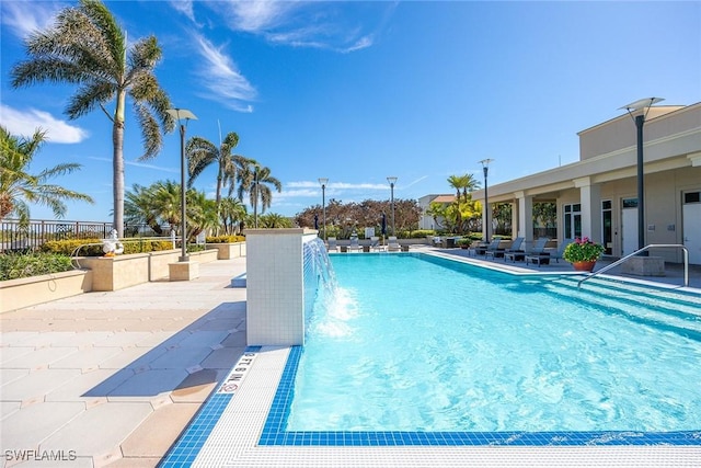 view of pool with a patio and pool water feature