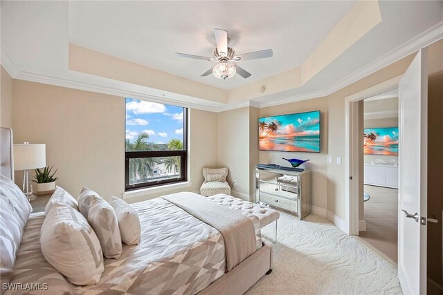 bedroom featuring crown molding, a tray ceiling, and ceiling fan