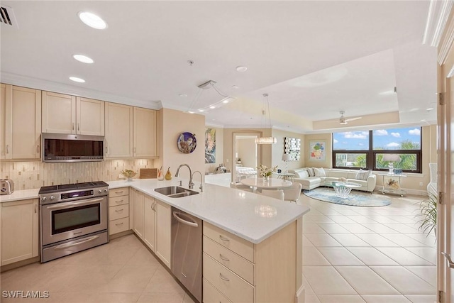 kitchen with stainless steel appliances, light tile patterned flooring, sink, and kitchen peninsula