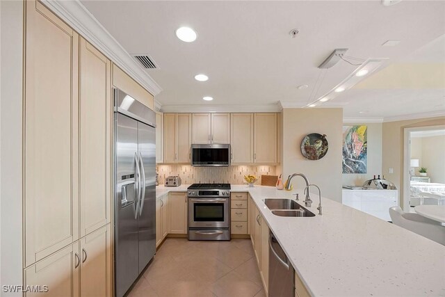 kitchen featuring sink, light tile patterned floors, backsplash, stainless steel appliances, and ornamental molding