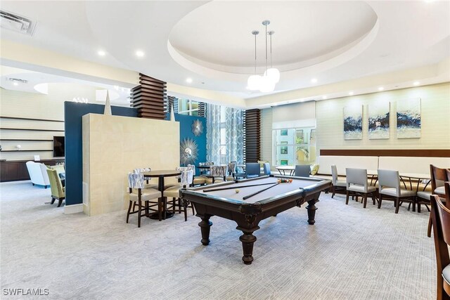 game room featuring billiards, light carpet, and a tray ceiling