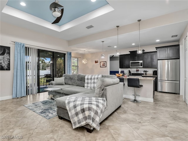 living room featuring a raised ceiling