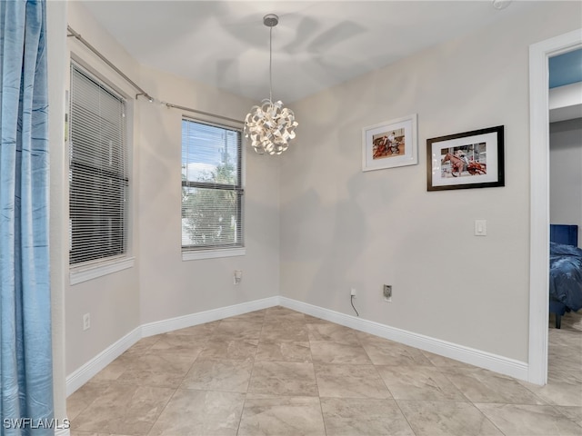 empty room featuring a chandelier