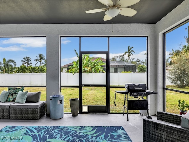 sunroom / solarium featuring ceiling fan