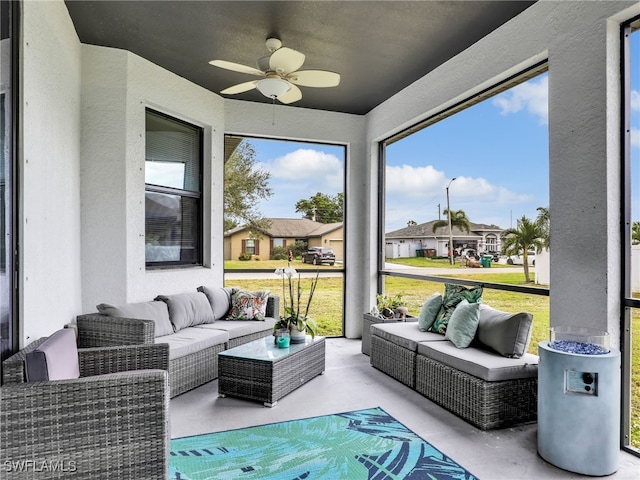 sunroom featuring ceiling fan