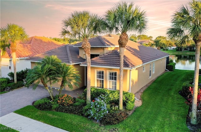 exterior space with a water view and a yard