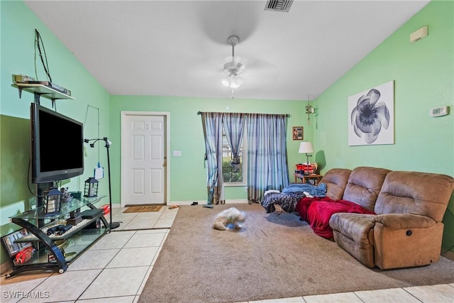 living room with ceiling fan, lofted ceiling, and light tile patterned flooring