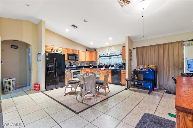 kitchen with light tile patterned flooring, black appliances, and lofted ceiling