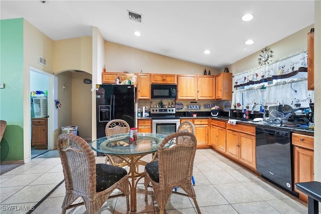 kitchen with light tile patterned flooring, black appliances, and vaulted ceiling