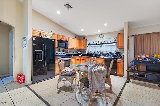 kitchen with sink, black appliances, lofted ceiling, and light tile patterned flooring