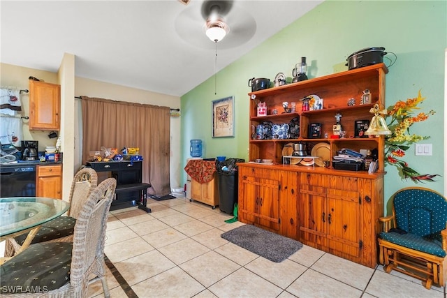 kitchen with ceiling fan, black dishwasher, lofted ceiling, and light tile patterned flooring