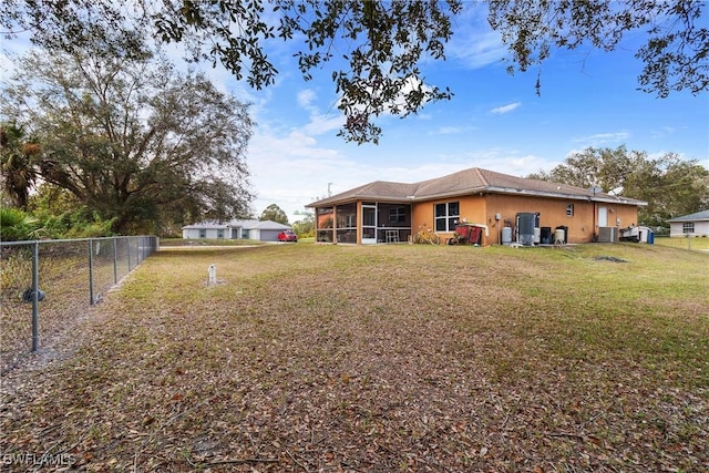 view of yard with a sunroom and central AC