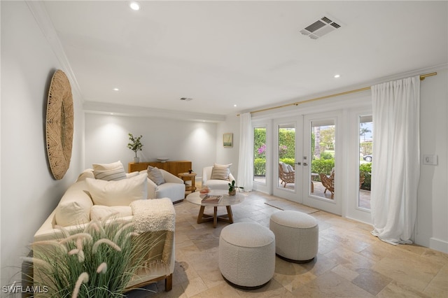 living area with stone tile floors, visible vents, french doors, and recessed lighting